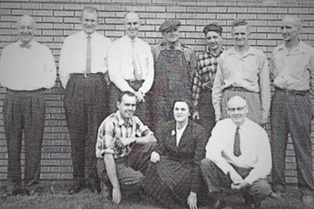 Vintage black and white photo of a group of workers.